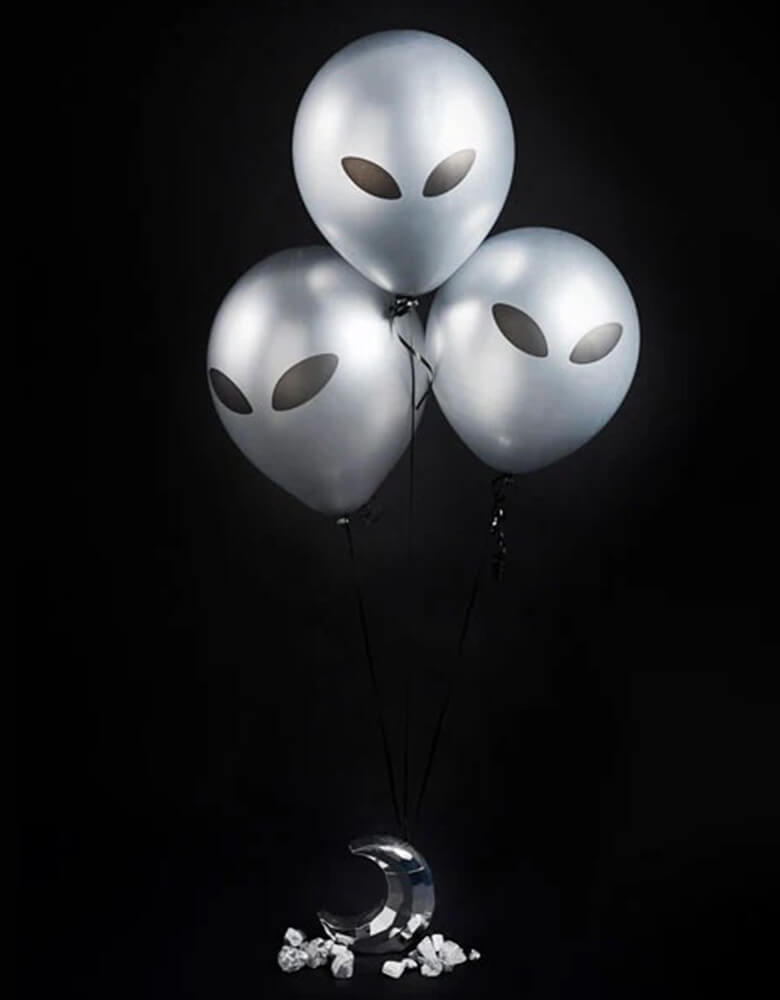 Three of Momo Party's 11" Alien Latex Balloons by Hooty Balloo. These silver alien balloons are a perfect addition to any space theme party! Transform any ordinary party into an out-of-this-world experience with these stellar silver alien balloons! Guaranteed to add a touch of intergalactic charm to your space-themed shindig!