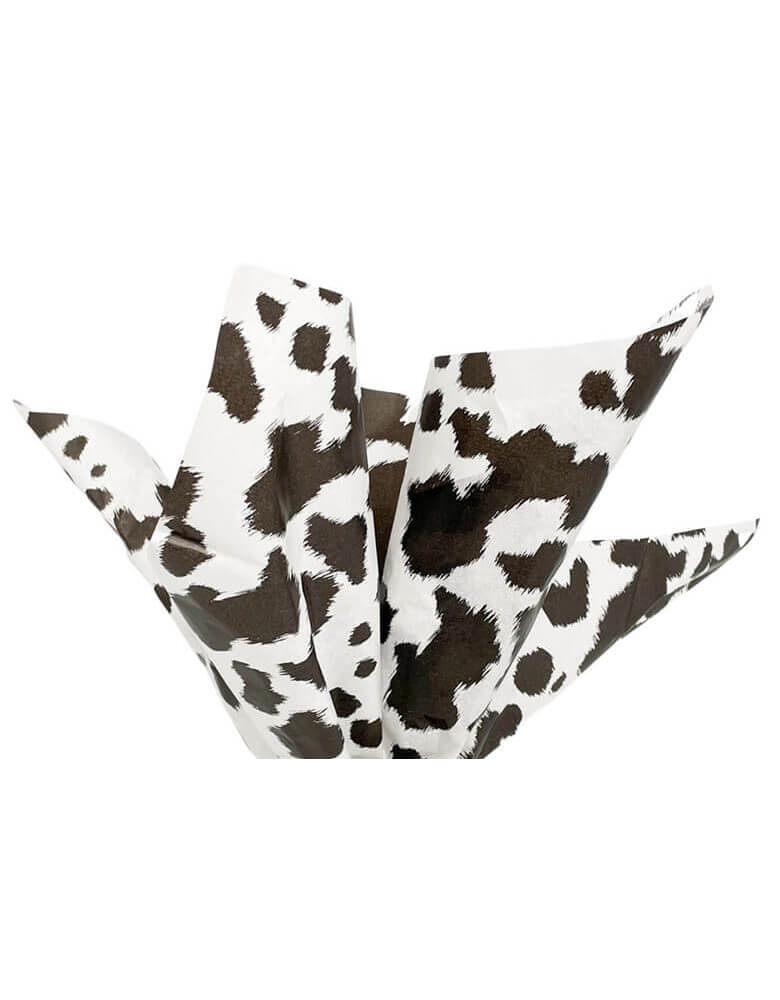 Momo Party's 19.75 x 27.5 Black Cowhide Print Tissue Paper by Party West. Comes in a set of 6 sheets, these tissue papers feature a western-inspired cowhide design and are perfect for any cowboy or cowgirl themed party. Use it for your snack basket, or party favor bags to set the scene!