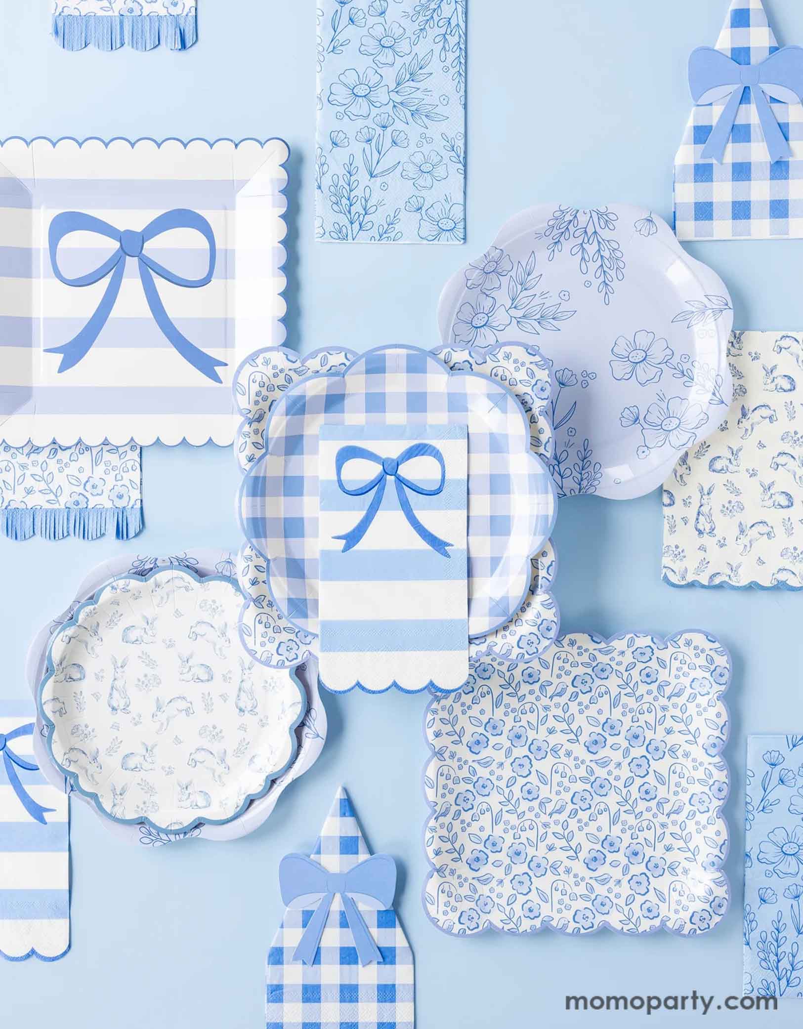 A blue tablescape showcase Momo Party's blue toile & striped bow party tableware collection by My Mind's Eye. Featuring various party plates, napkins in different sizes, shapes and spring inspired shapes including gingham checkered, elegant bows, floral toile, Easter bunny toile, this collection are perfect for your spring gatherings or Easter celebrations!