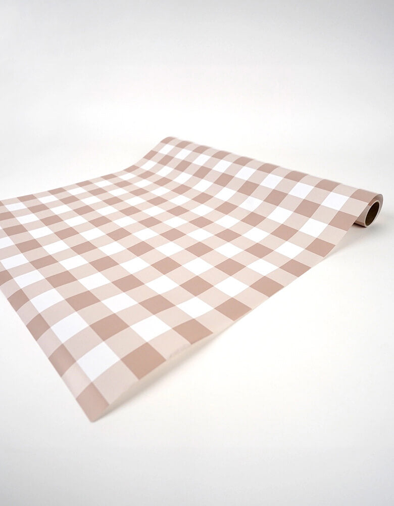 Momo Party's 18" x 120"  Brown Gingham Paper Table Runner by Gatherings. Bring the merriest of moments to your holiday table with this stylishly plaid brown gingham table runner! From buffets to family dinners, this festive pattern will add a touch of classic, cozy charm that will warm up any home. Perfect for the fall holidays! Add a ravishing look to your table top with our uniquely created table runners, making your table appear more lavish. Our table runners are 100% recyclable which helps with a swift!