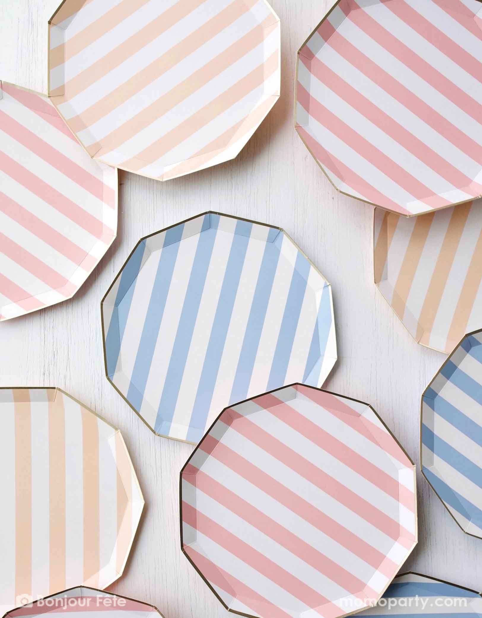 A table full of Momo Party's 10.75" Cabana Striped Paper Plates in different pastel colors including peach, pink and blue. These elegant blue sky decagon dinner plates feature a charming pastel stripe pattern for a soft touch. Perfect for adding a pop of color to your next gathering.