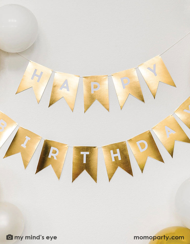 Momo Party's 4.5" x 6.5" Gold Foil Happy Birthday Word Banner by My Mind's Eye. Add a touch of celebratory flair with our Gold Foil Happy Birthday Word Banner! Perfect for any birthday bash, this fun and festive banner will make the guest of honor feel extra special. With elegant gold foil lettering, it's sure to make a statement. Let the party begin!