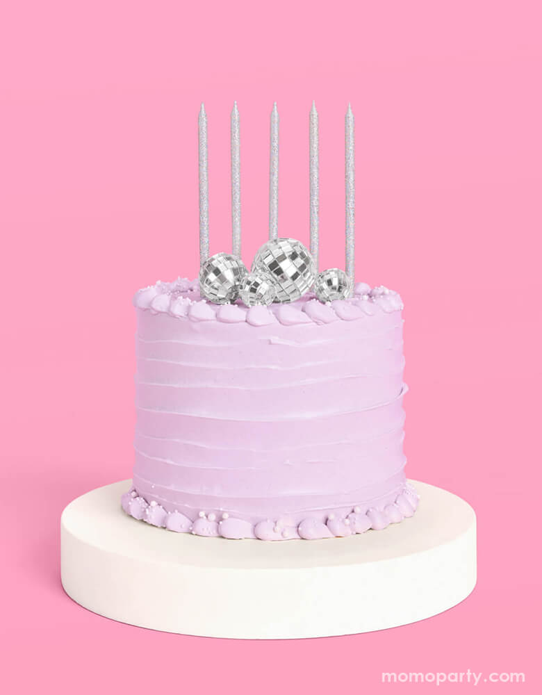 Momo Party's Disco Cake Toppers & five Iridescent Candles on a lilac buttercream birthday cake. This groovy topper and candle set is perfect for a disco themed celebration, a teenage girl's birthday, or a rock star, dace party or even a Taylor Swift themed birthday bash!