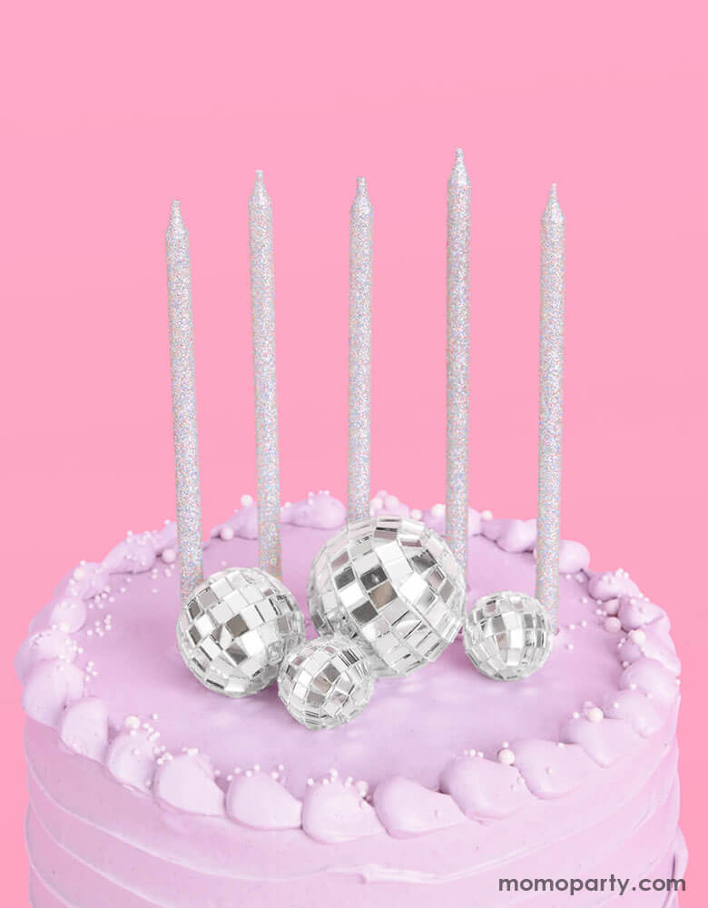 The overhead shot of Momo Party's Disco Cake Toppers & five Iridescent Candles on a lilac buttercream birthday cake. This groovy topper and candle set is perfect for a disco themed celebration, a teenage girl's birthday, or a rock star, dace party or even a Taylor Swift themed birthday bash!