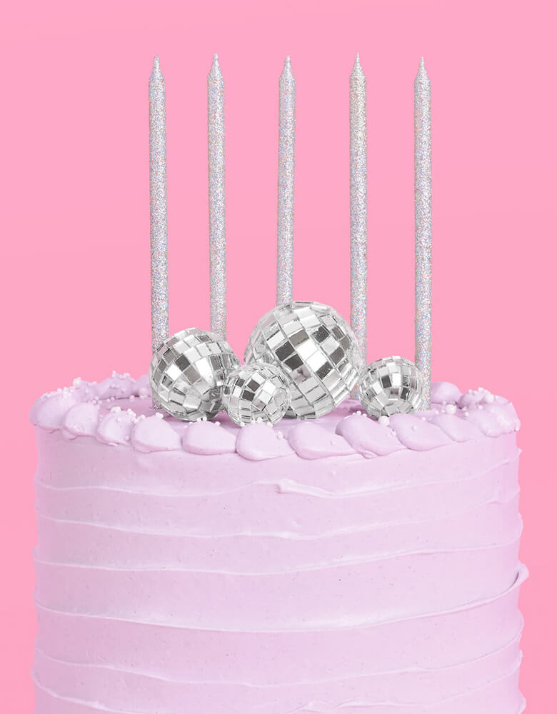 Momo Party's Disco Cake Toppers & five Iridescent Candles on a lilac buttercream birthday cake. This groovy topper and candle set is perfect for a disco themed celebration, a teenage girl's birthday, or a rock star, dace party or even a Taylor Swift themed birthday bash!