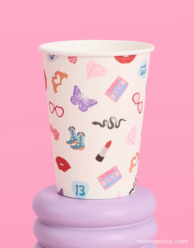 Momo Party's 12oz Taylor Swift Era's Party Paper Cups by Xo, Fetti. Comes in a set of 18 party cups, spice up your party with these Taylor Swift-inspired paper party cups! Your guests will be singing and dancing to the beat of these party cups featuring the iconic Taylor Swift-themed designs including snakes, butterflies, red lipsticks and more.