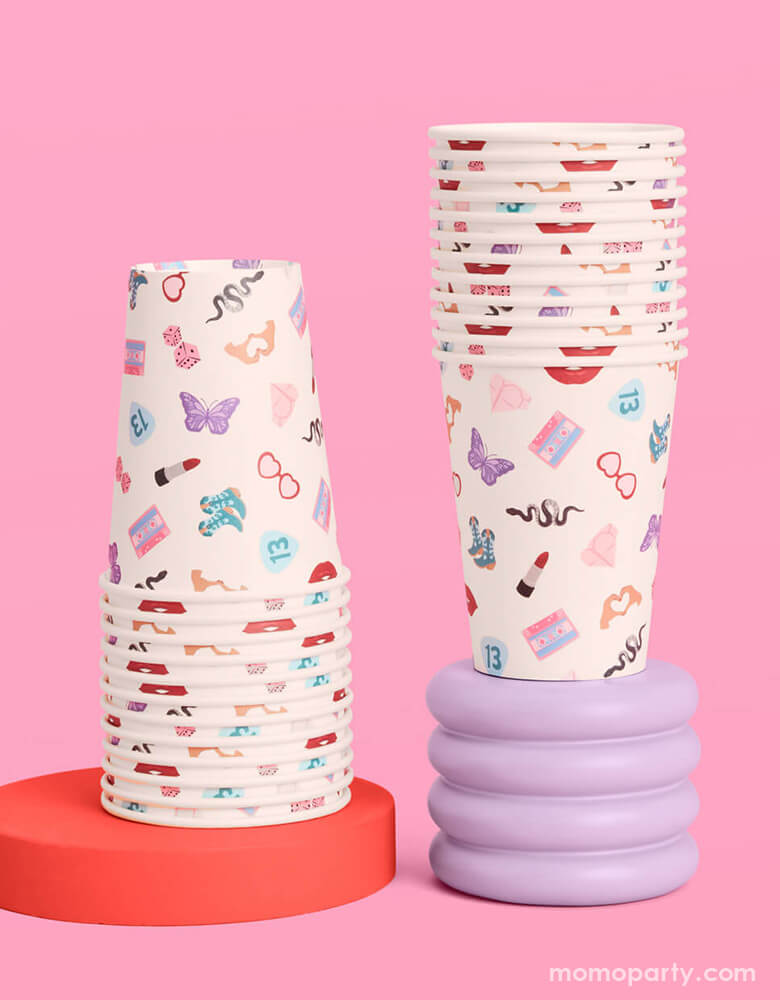 Momo Party's 12oz Taylor Swift Era's Party Paper Cups by Xo, Fetti. Comes in a set of 18 party cups, spice up your party with these Taylor Swift-inspired paper party cups! Your guests will be singing and dancing to the beat of these party cups featuring the iconic Taylor Swift-themed designs including snakes, butterflies, red lipsticks and more.