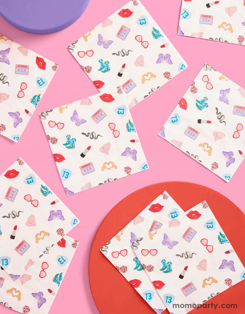 Momo Party's 5" x 5" Taylor Swift Era's Party small napkins Xo, Fetti. Comes in a set of 25 napkins, these napkins have a Taylor Swift inspired motif featuring red lipstick, red lips, butterflies, cowgirl boots, snakes, cassette tapes, guitar picks, heart hand symbols, and heart shaped sunglasses.  They're perfect for the party table celebrating your Swiftie girl's special day. 