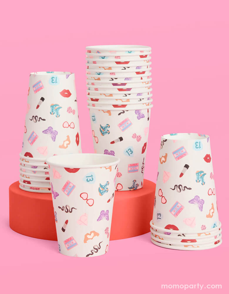 Momo Party's 12oz Taylor Swift Era's Party Paper Cups by Xo, Fetti. Comes in a set of 18 party cups, spice up your party with these Taylor Swift-inspired paper party cups! Your guests will be singing and dancing to the beat of these party cups featuring the iconic Taylor Swift-themed designs including snakes, butterflies, red lipsticks and more.