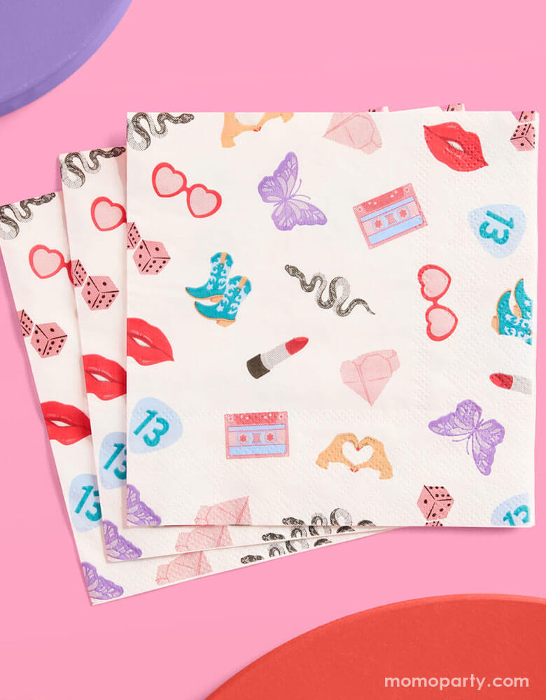 Momo Party's 5" x 5" Taylor Swift Era's Party small napkins Xo, Fetti. Comes in a set of 25 napkins, these napkins have a Taylor Swift inspired motif featuring red lipstick, red lips, butterflies, cowgirl boots, snakes, cassette tapes, guitar picks, heart hand symbols, and heart shaped sunglasses.  They're perfect for the party table celebrating your Swiftie girl's special day. 