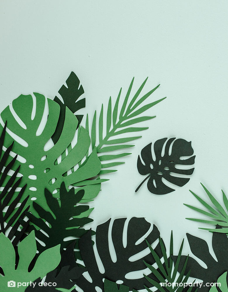 Momo Party's Tropical Leaves Decoration by Party Deco. These unique tropical leaf decorations contain 21 pieces - &nbsp; 7 different shapes of leaves, each shape in 3 shades of green color. Perfect for a tropical themed birthday party, fiesta or summer garden party.